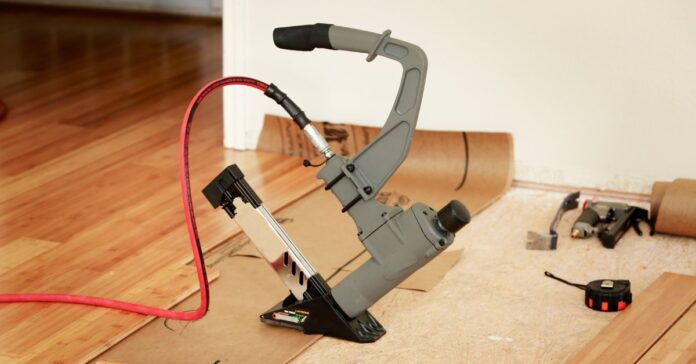A room being renovated has the subfloor visible in one half and new bamboo hardwood installed on the other half.