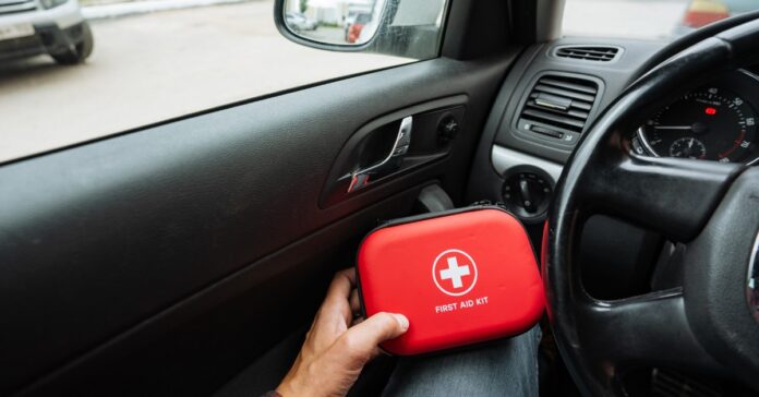 A view of a driver's hand as they hold a red container reading 