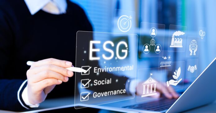 A businesswoman sits at her desk and checks off words in a digital box labeled ESG with a stylus.