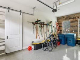 When Your Garage Needs To Do More Than Park Cars A clean residential garage has two sides separated by a wall, one side for parking cars, and the other side for storage.